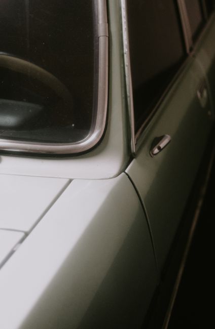 Close-up of a vintage car with retro design elements, showcasing its sleek and classic look.