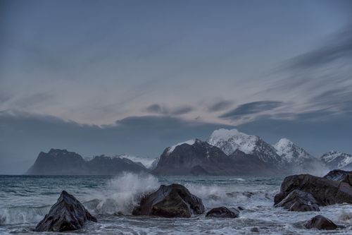 Free Stunning winter seascape with mountains and waves in Lofoten, Norway. Stock Photo