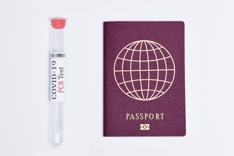 Passport Beside A Covid Test