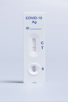 Detailed image of a COVID-19 rapid antigen test kit on a white background.