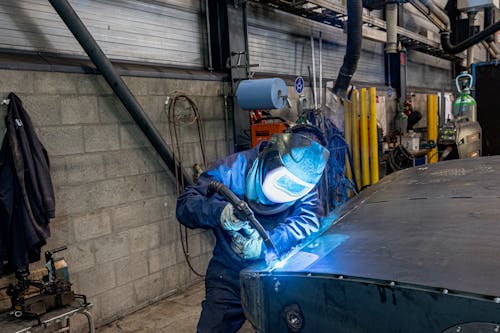 Person Welding Metal