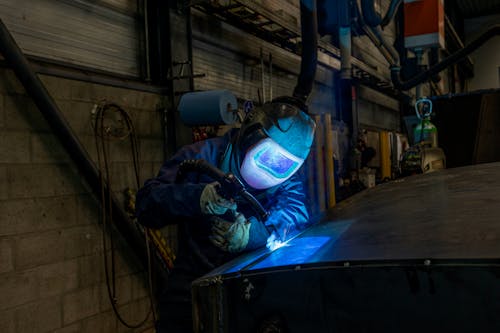 Person Welding a Metal