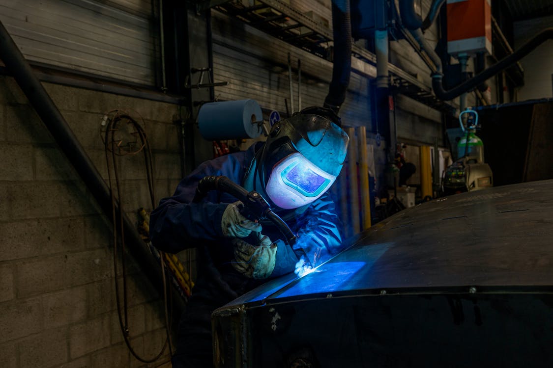 Person Welding a Metal