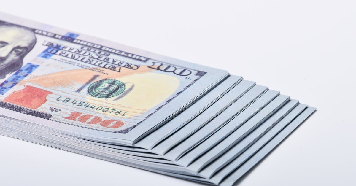 Close-Up Shot of Paper Money on White Surface · Free Stock Photo