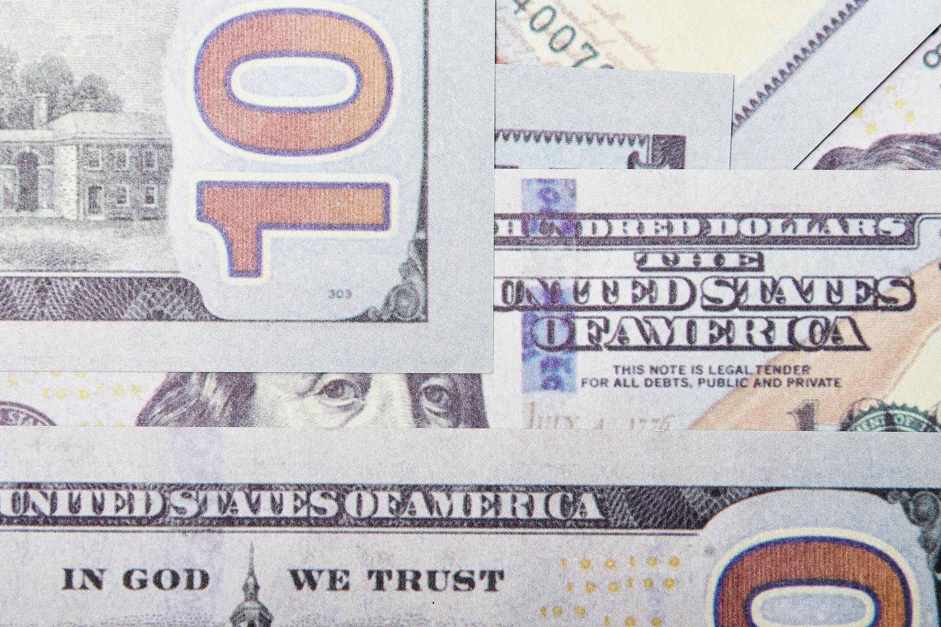 Detailed close-up of layered US dollar banknotes focusing on geometric patterns and financial concept.