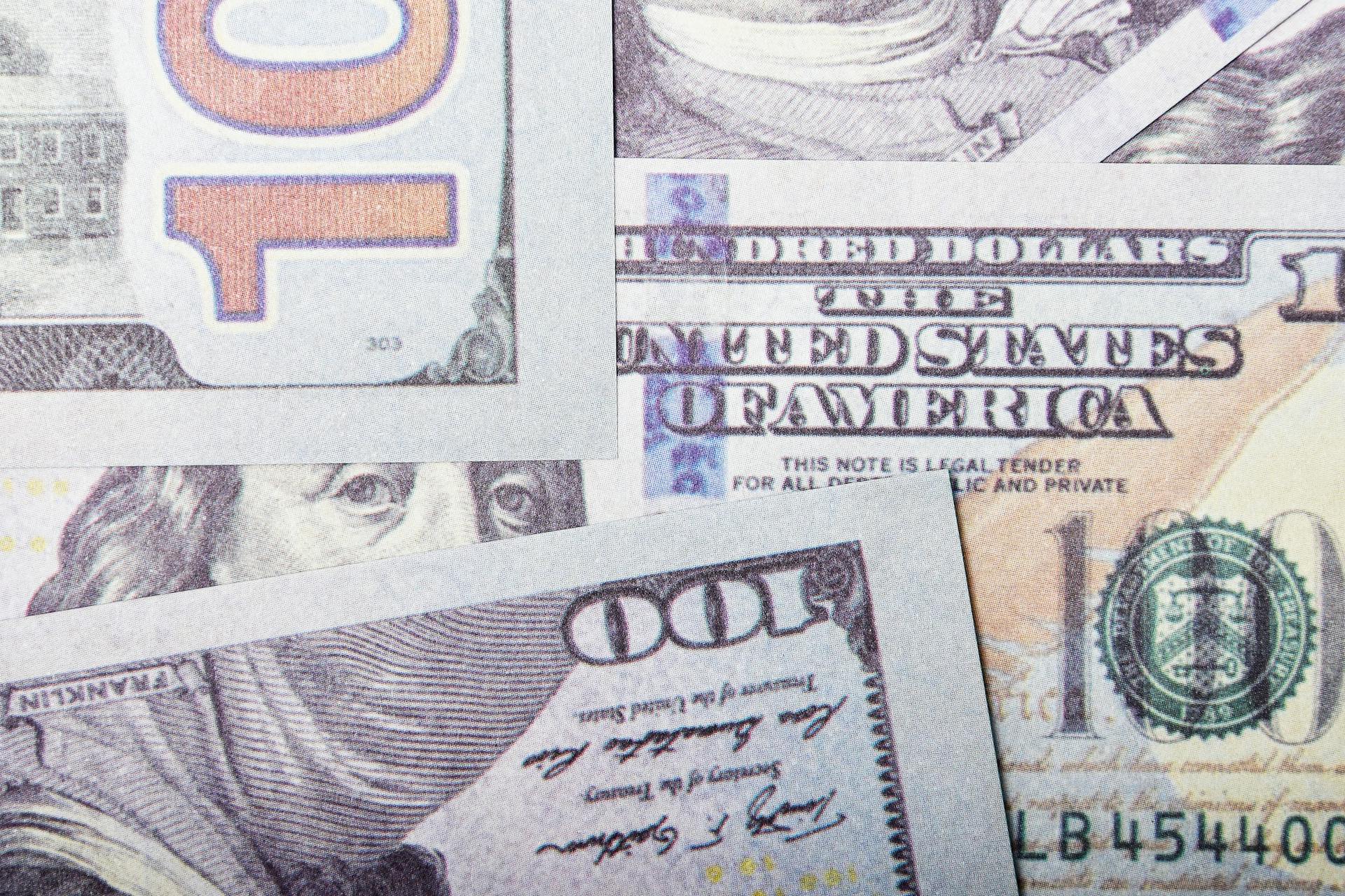 Detailed close-up of US dollar banknotes showcasing currency design and textures.