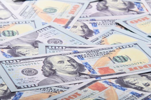 A detailed close-up of 100 US dollar bills showcasing Benjamin Franklin's portrait.