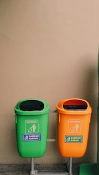 Green and orange waste bins in Indonesia for efficient recycling practices.