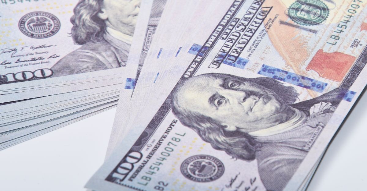 A close up of a stack of US Treasury bonds and a calculator
