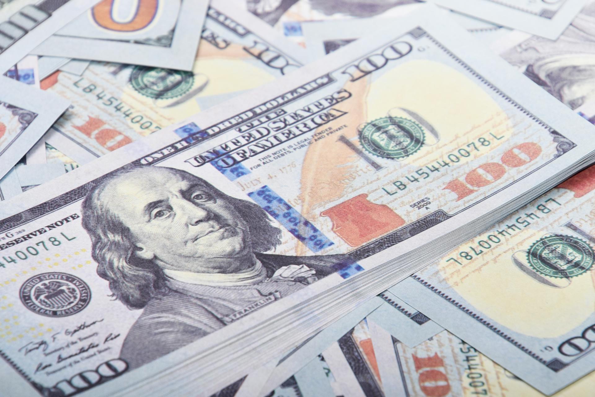 Detailed close-up of United States 100 dollar bills emphasizing currency and finance.