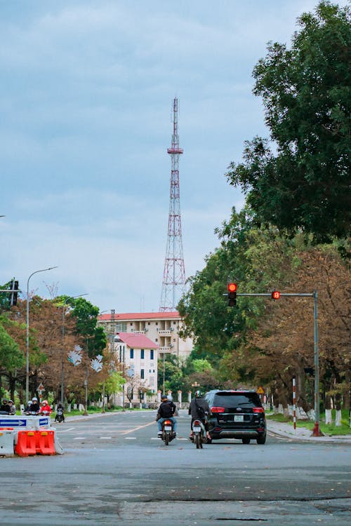 Car and Motorcycle Passing the Stoplight