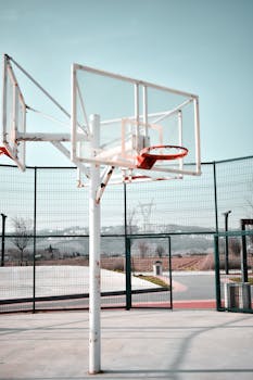 Peaceful outdoor basketball court in Turkey with an empty hoop and clear blue sky.