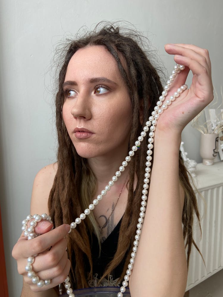 Woman Holding Pearl Necklace