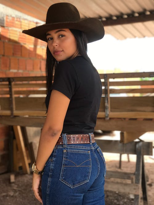 Free Woman in Denim Pants Wearing a Cowboy Hat Stock Photo