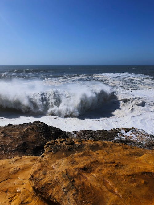 Ocean Waves Hitting Brown Rock