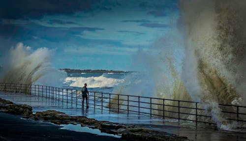 Free Person Standing Near the Ocean Stock Photo