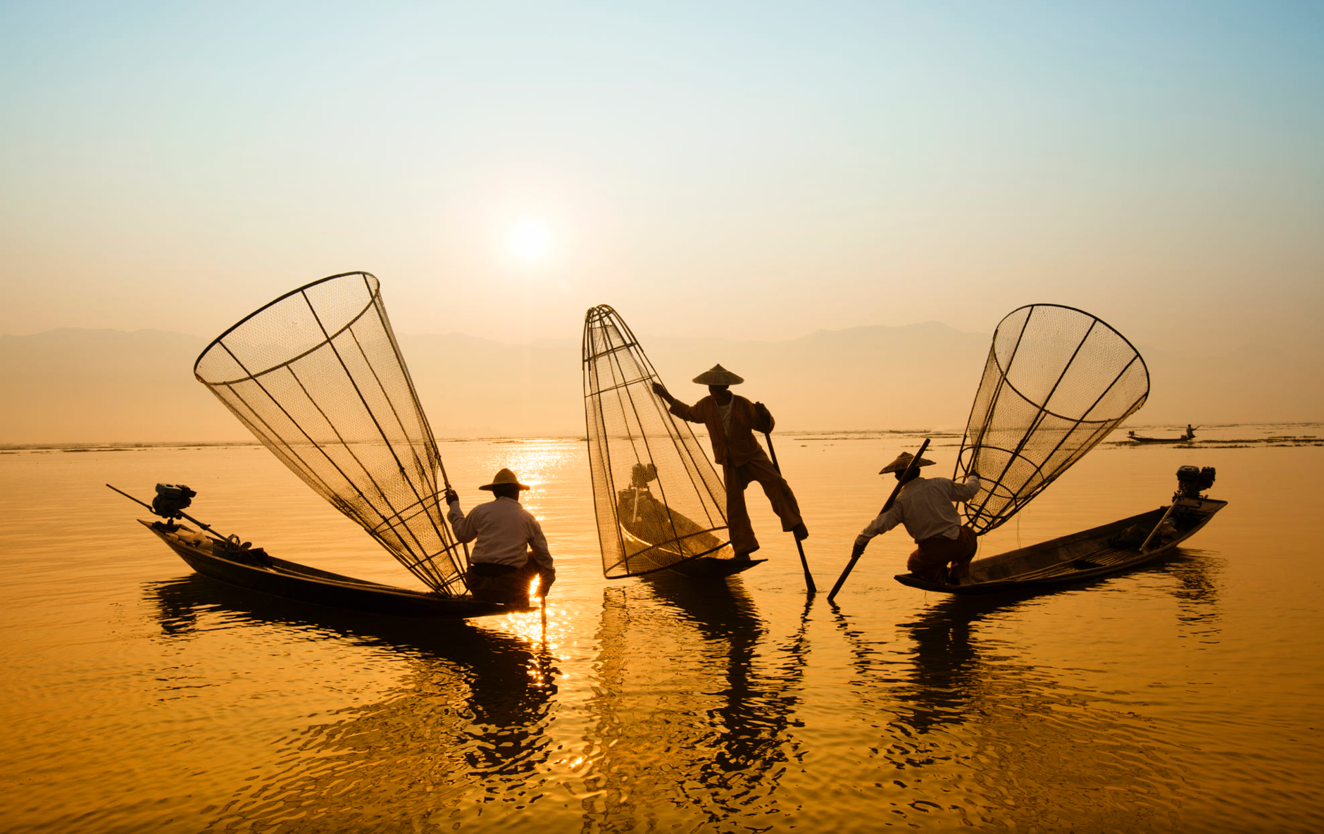Three Men Riding Boats on Body of Water · Free Stock Photo