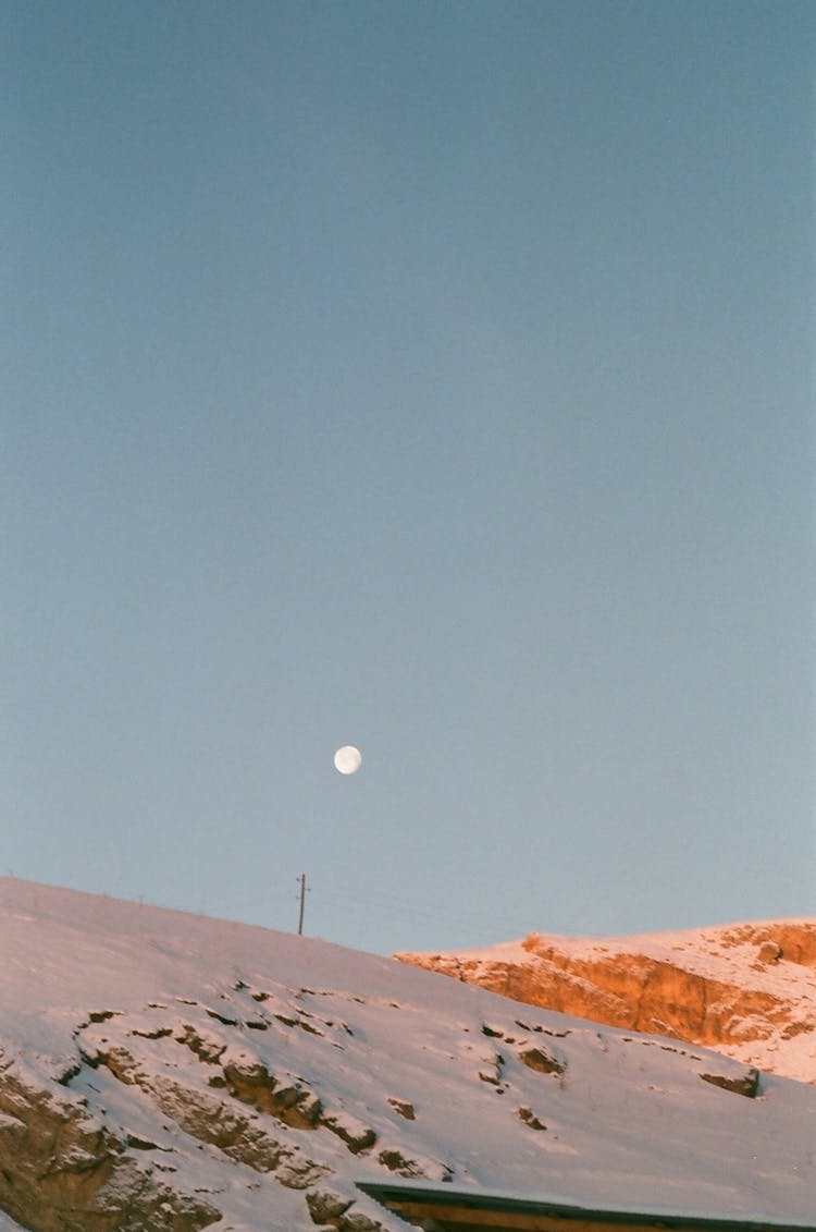 Moon Over Snow Covered Mountain