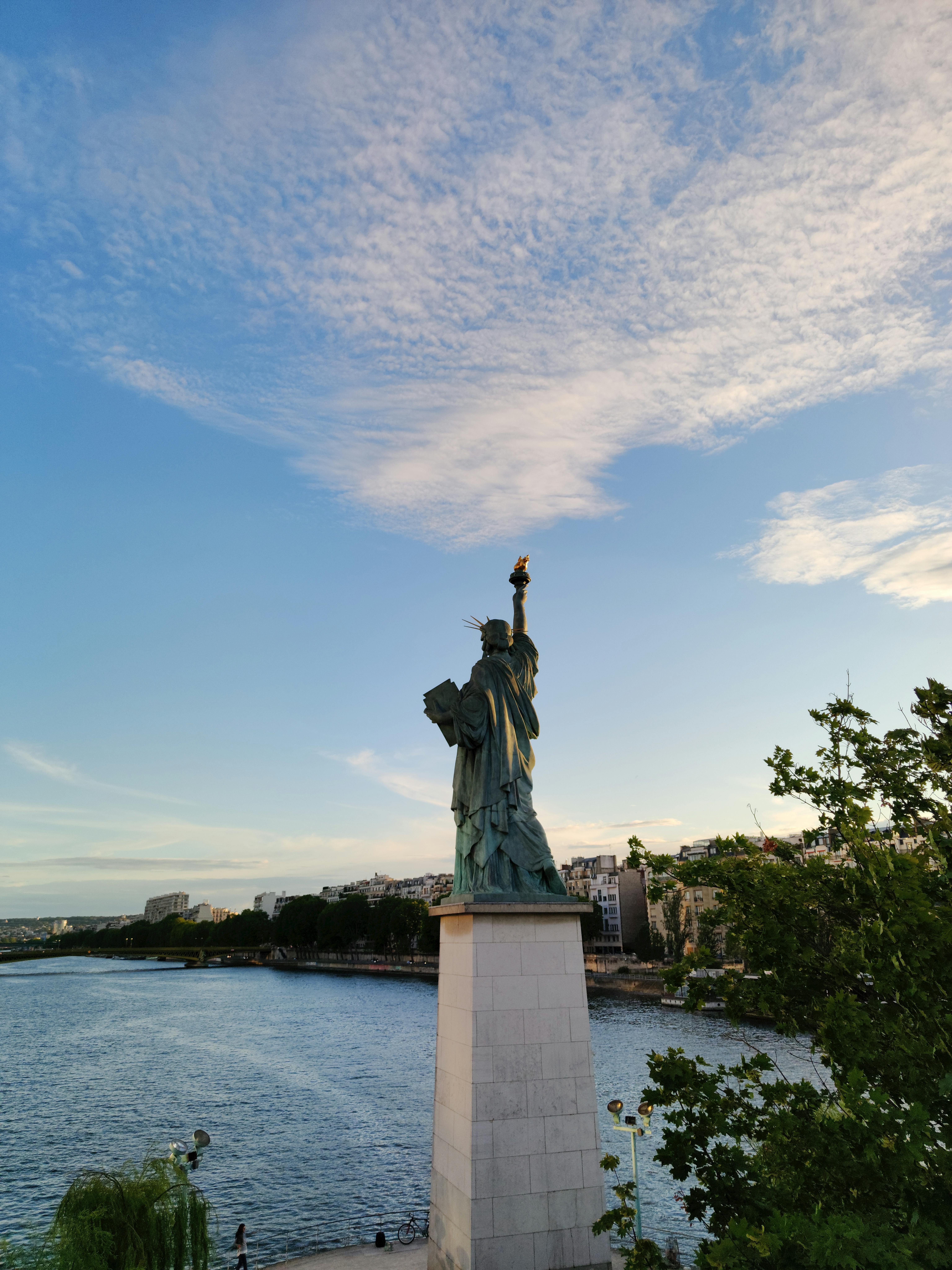 back view of a statue and waterfront