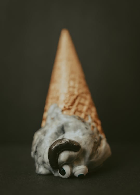 Gray Ice Cream with Cone on Black Surface 