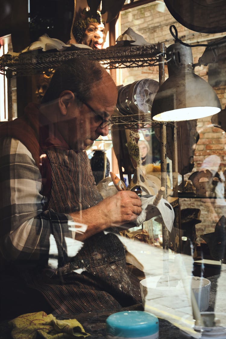 A Man Painting The Mask