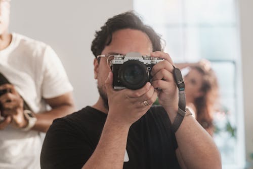 Close Up Photo of Man Taking Photo with a Camera