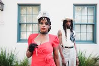 Fashion Models Posing in Front of Classic American House