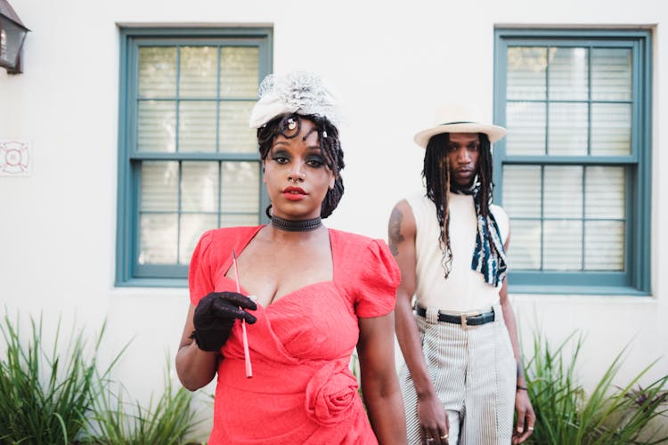 Fashion Models Posing In Front Of Classic American House