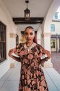 Woman with Strong Makeup and Frilled Dress in Ethnic Style Standing under Arcades