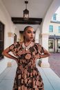 African American Woman in Frilled Dress with Ethnic Pattern