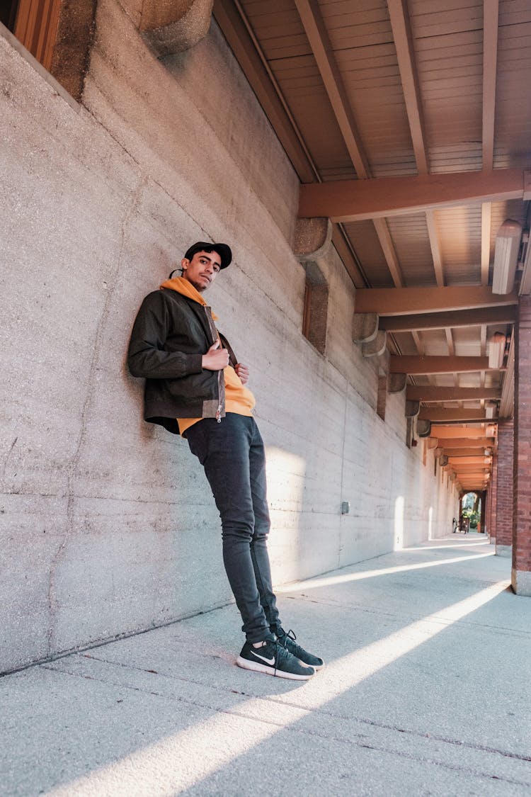 Man Leaning Against Tunnel Wall