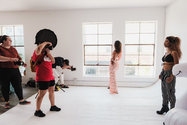 Group Of Photographers Taking Photos During Event In Studio