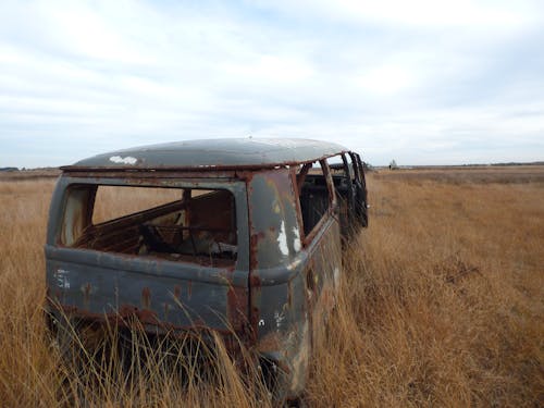 An Abandoned Vehicle on Grass Field