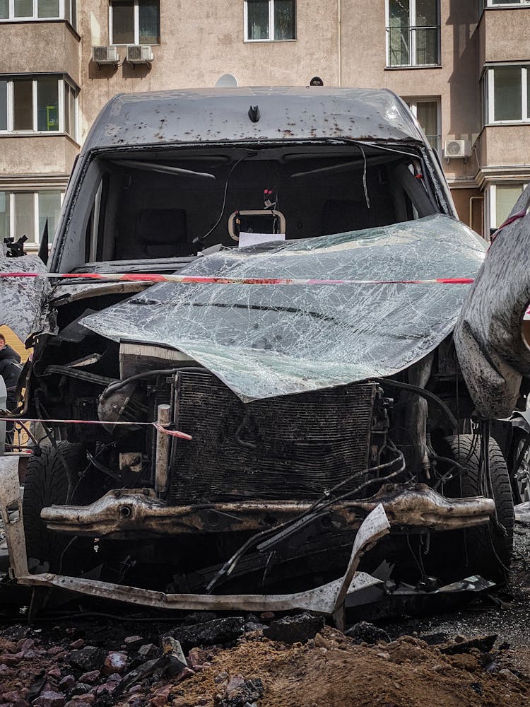 Destroyed Car By Residential Building