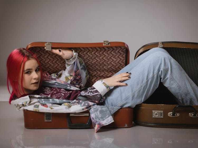 Woman Lying On Suitcases 