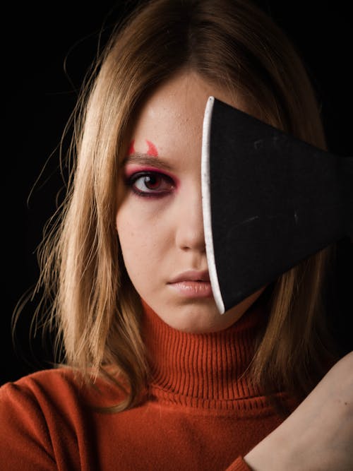 Close Up Photo of Axe near Woman's Face