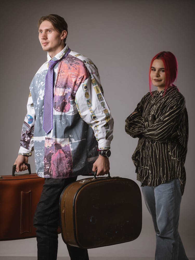 Woman And Man Carrying Suitcases