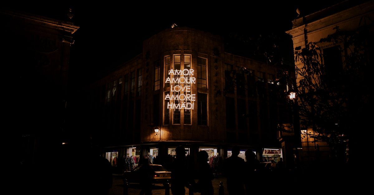 Illuminated Signage on a Building · Free Stock Photo