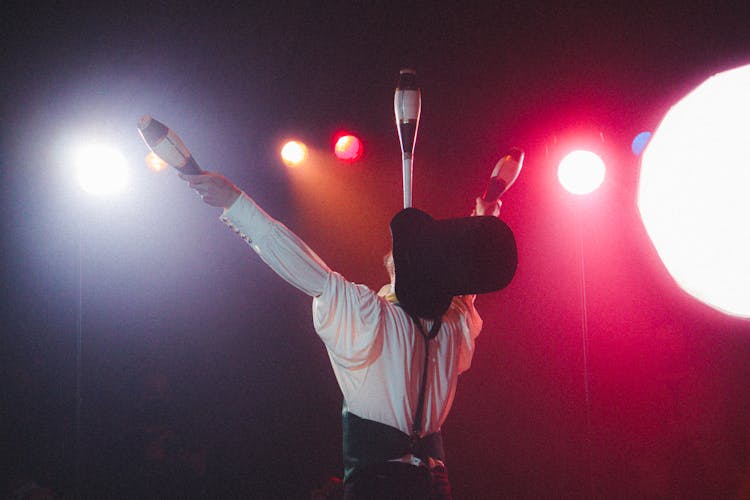 A Juggler Balancing Juggling Clubs