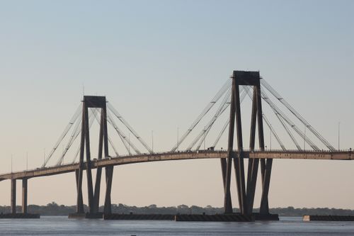 Free A breathtaking shot of the General Manuel Belgrano Bridge in Argentina, spanning over a calm river. Stock Photo