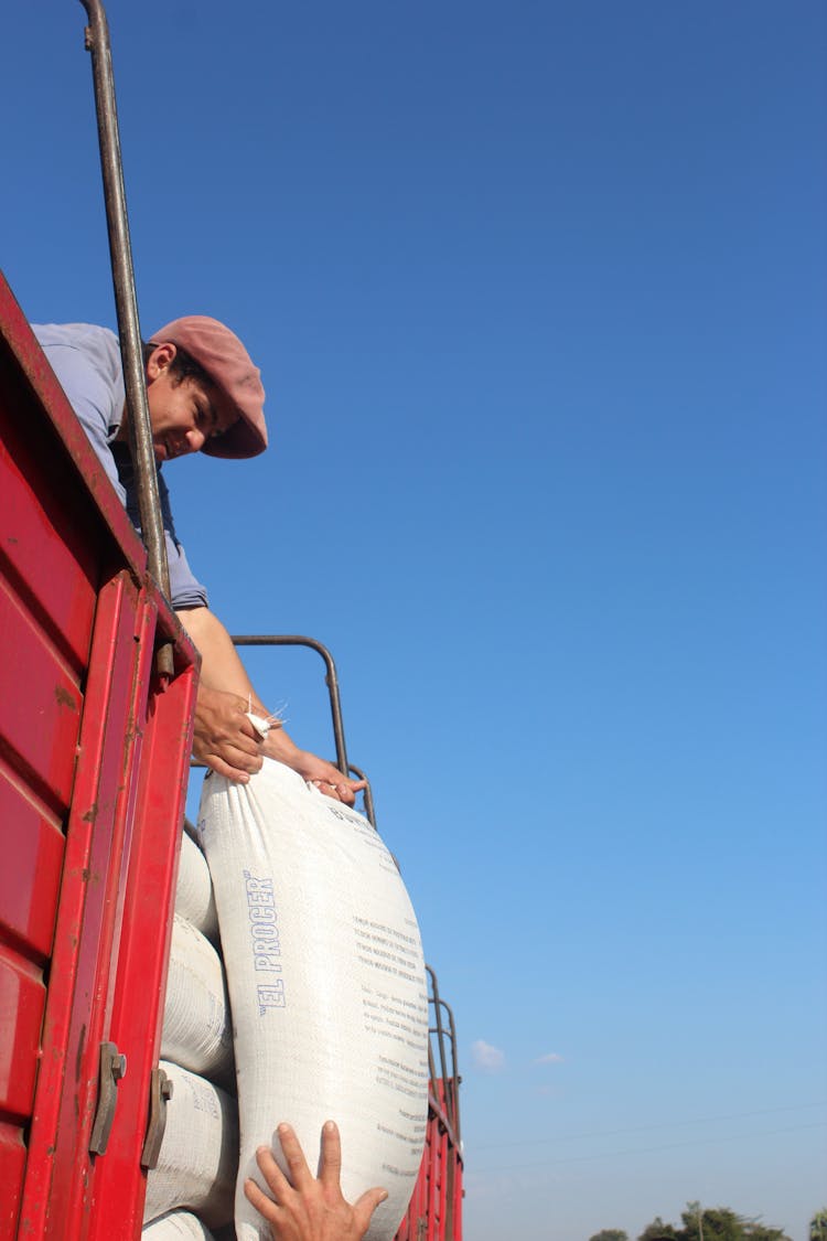 Man Holding A Bag From A Truck