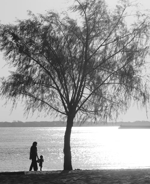 Mother and Child Standing by a Tree