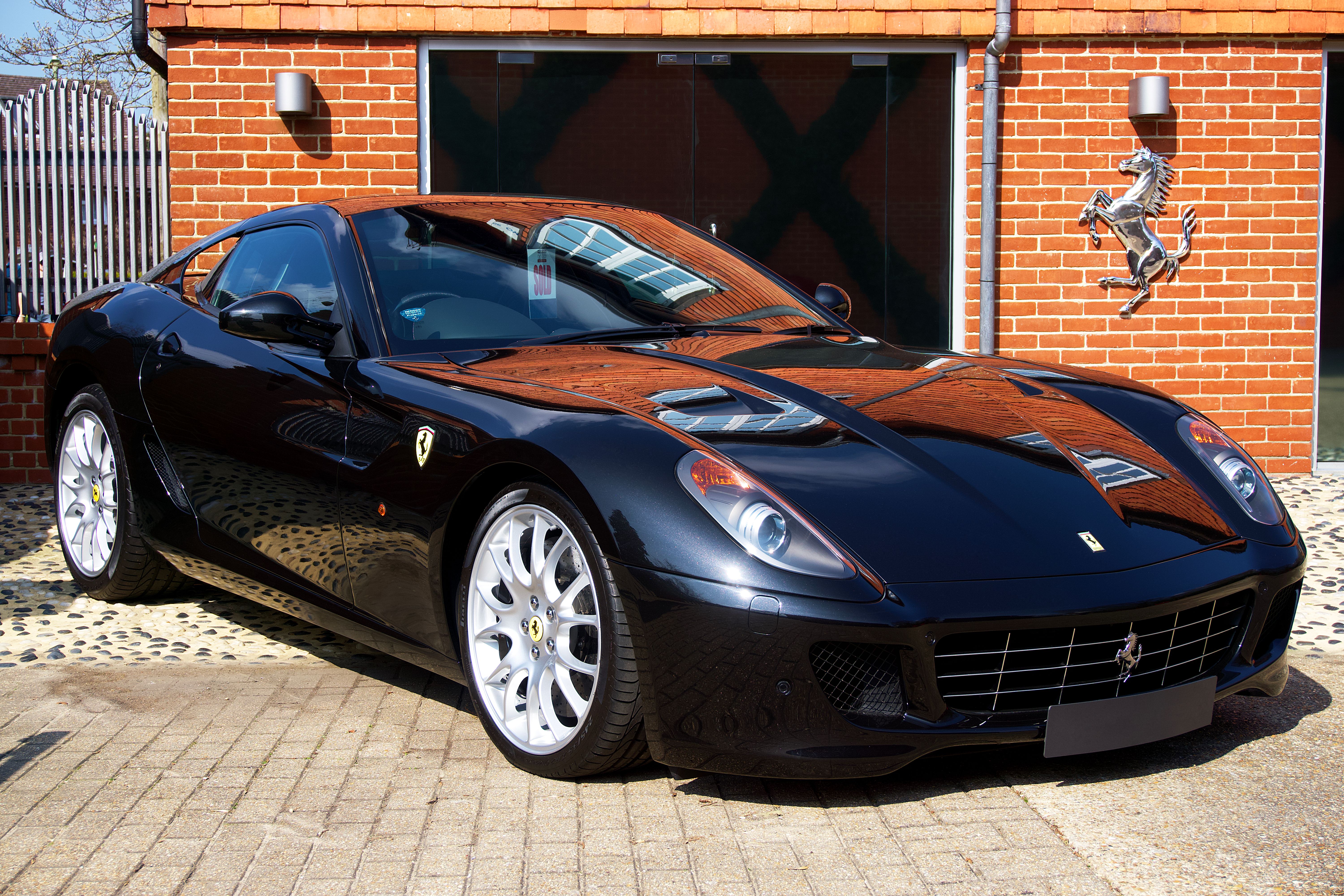 Luxurious black sports car parked in an urban setting, exuding power and elegance.
