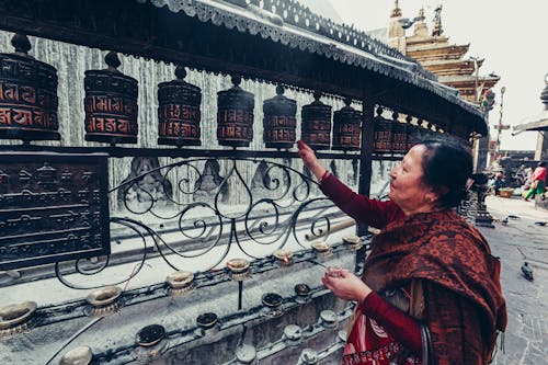 Woman in Traditional Clothing near Temple