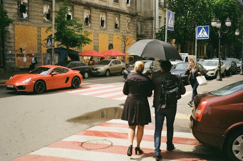 Free People with Umbrella Walking on the Pedestrian Lane Stock Photo