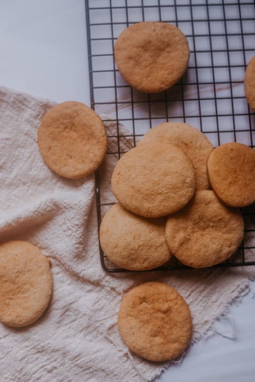 Free Freshly baked cookies on a cooling rack with a rustic background. Stock Photo