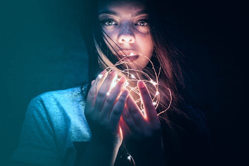 Woman Holding String Lights