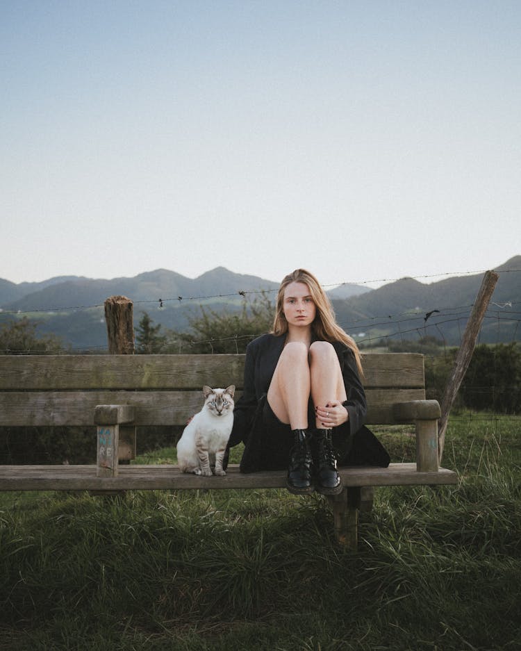 Woman And Cat Sitting On Bench