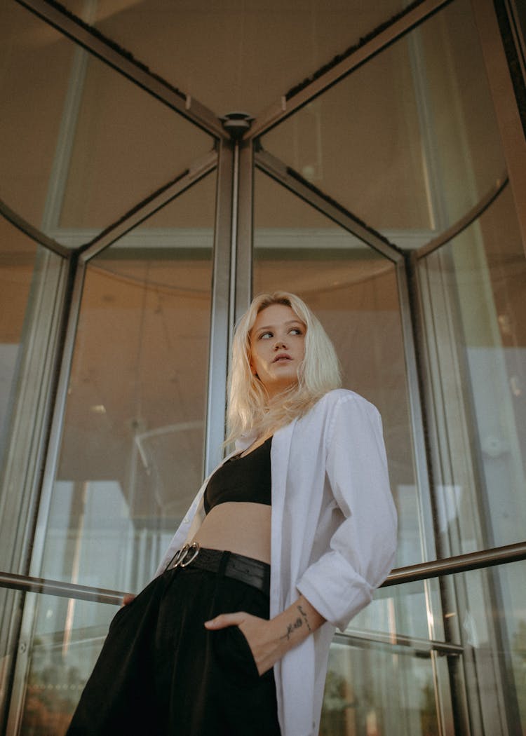 Woman Leaning Against Glass Revolving Door