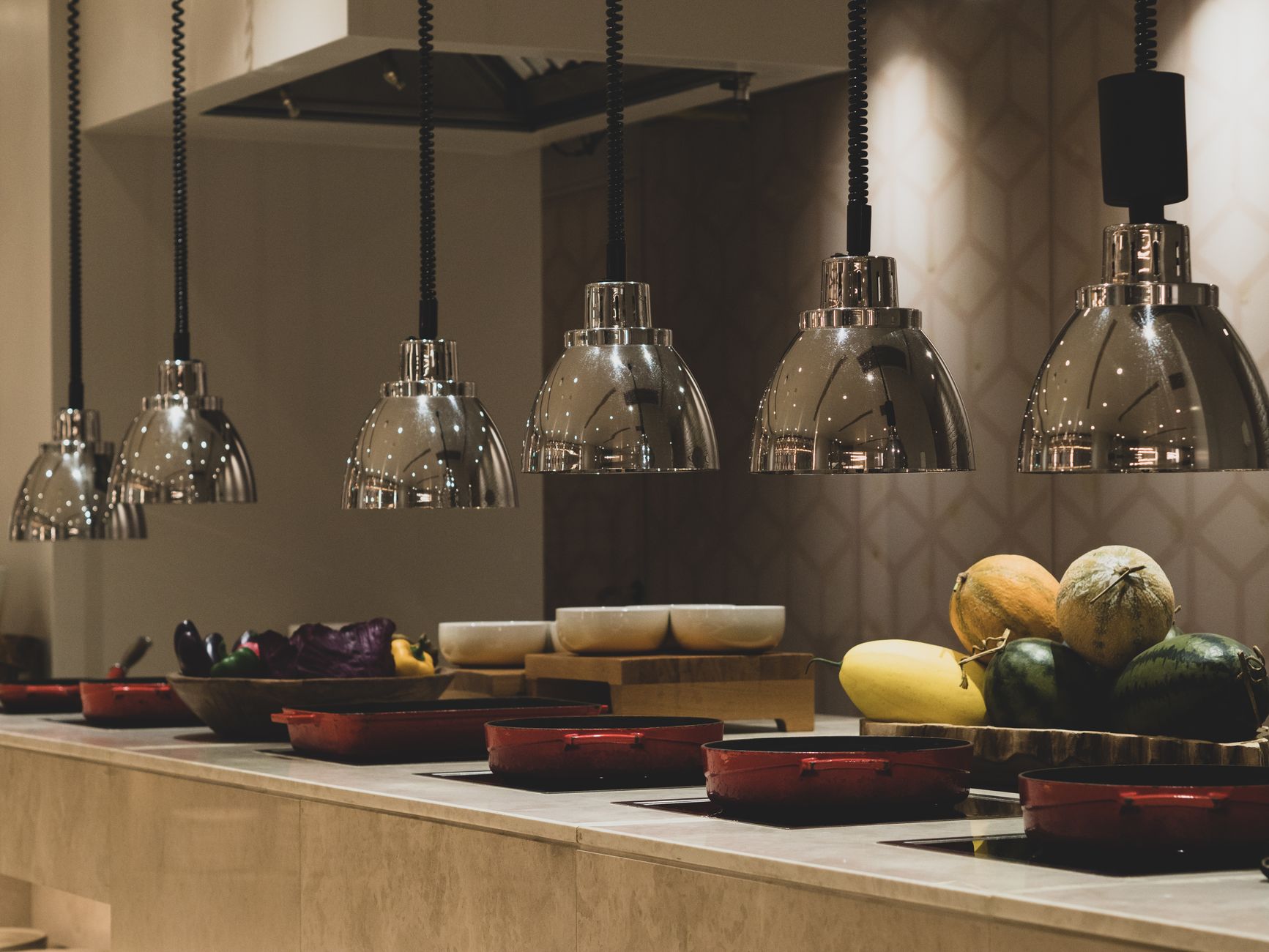 Stylish countertop buffet with pendant lights and diverse food selection in Corfu, Greece.